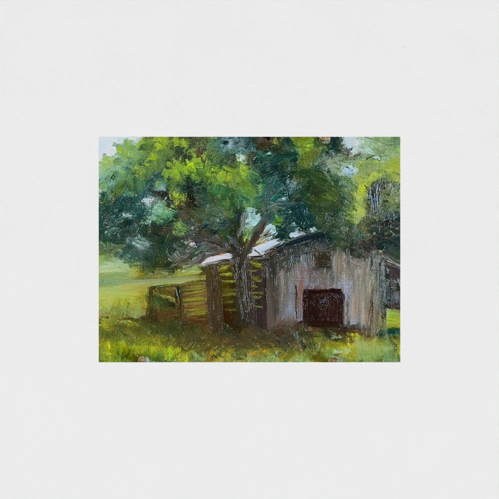 Impressionist painting of a weathered barn with green trees and warm golden light